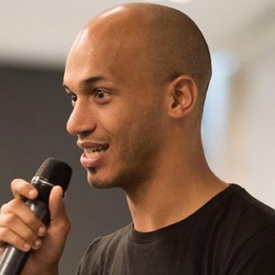 Lério Cunha delivering a keynote as a motivational speaker at a national convention in the UK